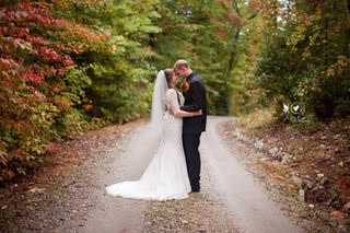 Bride and groom standing on a dirt road